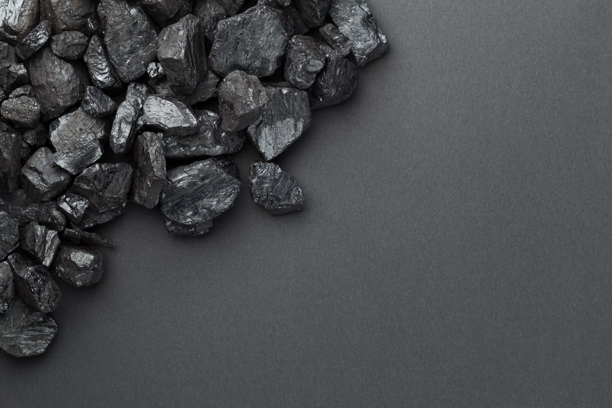 black coal pile over dark background